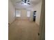 Spacious bedroom featuring neutral carpet, ceiling fan, and bright natural light at 4215 Wildener Way, Cumming, GA 30041