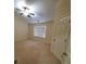 A spacious bedroom with a ceiling fan, large window, and neutral carpet at 4215 Wildener Way, Cumming, GA 30041