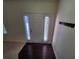 Entryway with dark wood flooring, a white door, coat hooks, and a view to the living room at 4215 Wildener Way, Cumming, GA 30041