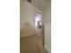 A carpeted hallway leads to a bedroom with a ceiling fan and plenty of light at 4215 Wildener Way, Cumming, GA 30041