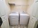 A laundry room featuring a modern washer and dryer set with overhead shelving at 4215 Wildener Way, Cumming, GA 30041