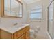 Bright bathroom with a white vanity, a toilet, and a combined tub and shower behind a sliding glass door at 4480 Highway 5, Douglasville, GA 30135