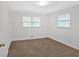 Bedroom features neutral walls, a ceiling fan, plush carpeting, and a window for natural light at 4480 Highway 5, Douglasville, GA 30135