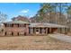 Charming brick home featuring a metal roof and covered carport on a sunny day at 4480 Highway 5, Douglasville, GA 30135