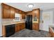 Traditional kitchen featuring ample wood cabinetry, modern appliances, and durable gray flooring at 4480 Highway 5, Douglasville, GA 30135