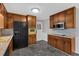 Traditional kitchen featuring ample wood cabinetry, modern appliances, and durable gray flooring at 4480 Highway 5, Douglasville, GA 30135