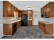 Traditional kitchen featuring ample wood cabinetry, modern appliances, and durable gray flooring at 4480 Highway 5, Douglasville, GA 30135