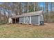 Shed on a large homesite with grey wood and white trim at 4480 Highway 5, Douglasville, GA 30135