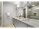 Modern bathroom with double vanity, quartz countertop, and large mirror showcasing tiled shower at 105 City View Ne Ct, Atlanta, GA 30308