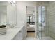 Bright bathroom featuring double sink vanity with quartz countertop and glass-enclosed shower at 105 City View Ne Ct, Atlanta, GA 30308