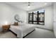 Bright bedroom with a large window, plush bedding, neutral tones and two side tables at 105 City View Ne Ct, Atlanta, GA 30308