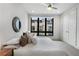 Cozy bedroom featuring plush bedding, a side table, neutral colors, and a large window at 105 City View Ne Ct, Atlanta, GA 30308