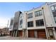 A row of modern townhomes features brick accents, private garages, and sleek window designs at 105 City View Ne Ct, Atlanta, GA 30308