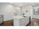 Clean and modern kitchen island featuring white countertops, a sink, and stainless steel dishwasher at 105 City View Ne Ct, Atlanta, GA 30308