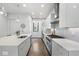 Sleek kitchen featuring white cabinets, stainless steel appliances, and a kitchen island with a sink at 105 City View Ne Ct, Atlanta, GA 30308