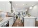 Modern kitchen with stainless steel appliances, white cabinetry, and open floor plan flowing into the living area at 105 City View Ne Ct, Atlanta, GA 30308