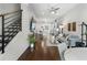 Spacious living room with hardwood floors, modern decor, and open staircase at 105 City View Ne Ct, Atlanta, GA 30308