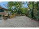 Backyard area with parking and featuring a wooden fence with mature trees at 1181 Fairview Ne Rd, Atlanta, GA 30306