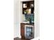 An alcove bar has a wine fridge, cabinets, shelves with decor, and a backsplash in a lovely home at 1181 Fairview Ne Rd, Atlanta, GA 30306