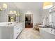 Luxury bathroom featuring marble floors, soaking tub, and walk-in closet at 1181 Fairview Ne Rd, Atlanta, GA 30306