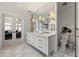 Well-lit bathroom featuring marble floors, dual vanity, and walk-in shower at 1181 Fairview Ne Rd, Atlanta, GA 30306