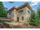 The rear exterior elevation featuring a brick facade with large windows and a walkout patio at 1181 Fairview Ne Rd, Atlanta, GA 30306