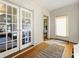 Inviting entryway featuring hardwood floors, a decorative rug, and glass French doors leading to a bright, sunlit room at 1181 Fairview Ne Rd, Atlanta, GA 30306