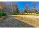 Large, grassy front yard of a home, shaded by mature trees on a sunny day at 1181 Fairview Ne Rd, Atlanta, GA 30306