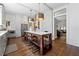 A gorgeous kitchen with an island features hardwood floors, modern light fixtures, and stainless appliances at 1181 Fairview Ne Rd, Atlanta, GA 30306