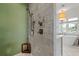 Shower with marble walls, rainfall shower head, and green accent wall at 1181 Fairview Ne Rd, Atlanta, GA 30306