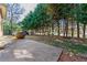 Spacious side yard featuring a tree line, swing, and concrete pathway at 1181 Fairview Ne Rd, Atlanta, GA 30306