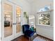 Cozy sitting area with hardwood floors, natural light, and a bright blue accent chair at 1181 Fairview Ne Rd, Atlanta, GA 30306