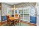 Sunny breakfast nook with floral wallpaper, hardwood floors, and a view of the backyard at 1274 Creek Laurel Dr, Lawrenceville, GA 30043