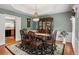 Elegant dining room featuring wainscoting, decorative lighting, and a dark wood dining set at 1274 Creek Laurel Dr, Lawrenceville, GA 30043