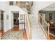 Bright foyer with hardwood floors, staircase with white risers and wood railing leading to the second floor at 1274 Creek Laurel Dr, Lawrenceville, GA 30043