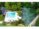 Aerial view of a community pool and pond surrounded by trees, offering a relaxing outdoor amenity for residents at 24308 Plantation Ne Dr, Atlanta, GA 30324