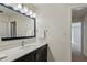 Bright bathroom with white marble countertop, a blue vanity, and hallway access at 24308 Plantation Ne Dr, Atlanta, GA 30324