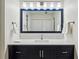 Modern bathroom vanity with dark blue cabinets, white quartz countertop, and large mirror at 24308 Plantation Ne Dr, Atlanta, GA 30324