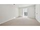 Bright bedroom features neutral carpet, natural light from a window, and fresh paint for a serene atmosphere at 24308 Plantation Ne Dr, Atlanta, GA 30324