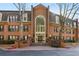 Classic brick building with arched window, manicured landscaping, and convenient bench seating at 24308 Plantation Ne Dr, Atlanta, GA 30324