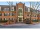 Charming brick building featuring a grand entryway with a striking arched window and meticulously maintained landscaping at 24308 Plantation Ne Dr, Atlanta, GA 30324