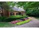 Charming two-story brick home with beautiful landscaping, enhancing curb appeal and creating a welcoming entrance at 24308 Plantation Ne Dr, Atlanta, GA 30324