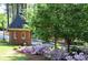 Charming guardhouse surrounded by manicured landscaping and blooming azaleas adding to curb appeal at 24308 Plantation Ne Dr, Atlanta, GA 30324