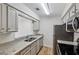 Modern kitchen featuring stainless steel appliances, granite countertops, and white cabinetry at 24308 Plantation Ne Dr, Atlanta, GA 30324