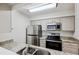 Modern kitchen features stainless steel appliances, sleek granite countertops, and bright lighting at 24308 Plantation Ne Dr, Atlanta, GA 30324