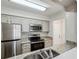 Well-lit kitchen with stainless steel appliances, granite countertops, and updated cabinetry at 24308 Plantation Ne Dr, Atlanta, GA 30324
