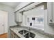 Kitchen pass-through provides view to living room, connecting the spaces with granite countertops at 24308 Plantation Ne Dr, Atlanta, GA 30324