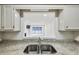 Kitchen pass-through to living room, granite countertop, and stainless steel sink at 24308 Plantation Ne Dr, Atlanta, GA 30324