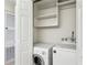 A functional laundry closet with a washer and dryer, maximizing space with convenient built-in shelving at 24308 Plantation Ne Dr, Atlanta, GA 30324