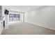 Spacious living area with a cozy fireplace, large windows for natural light, and neutral carpeting at 24308 Plantation Ne Dr, Atlanta, GA 30324